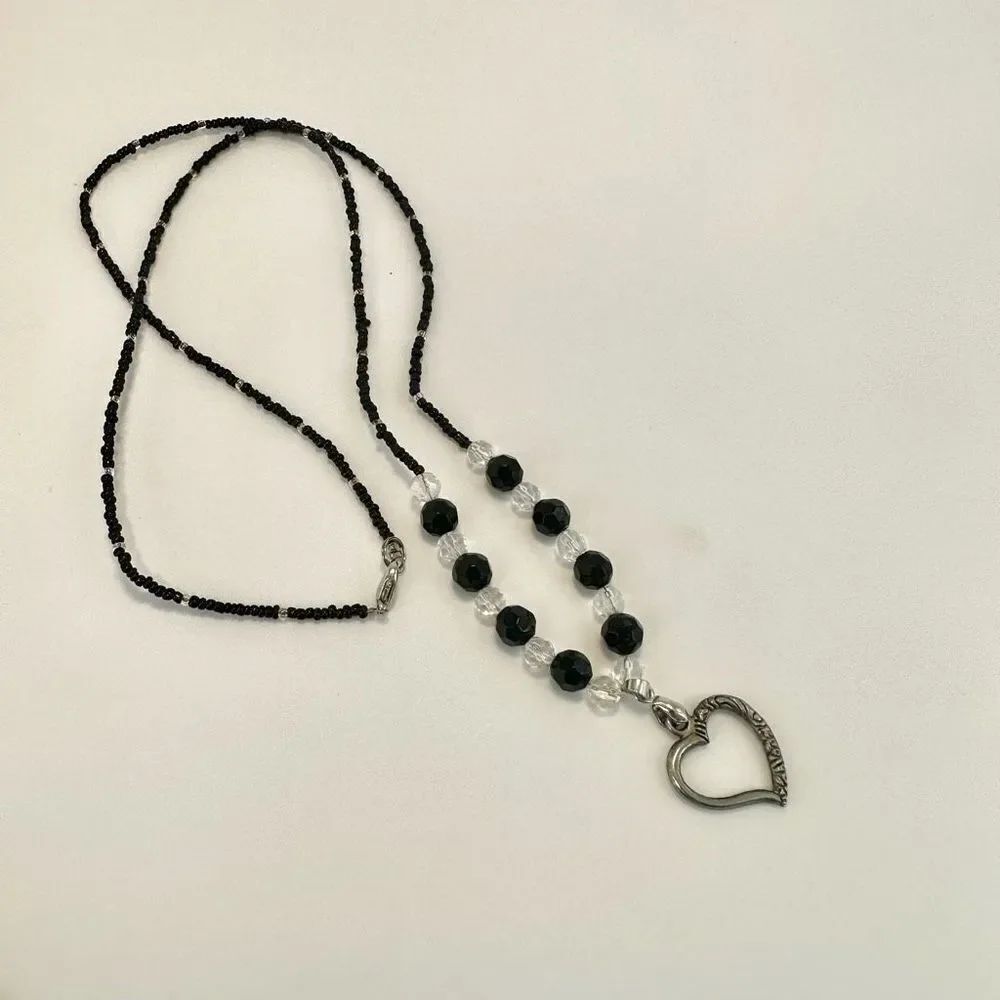 Silver tone and black beadedāheart pendant necklace